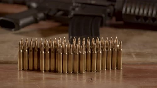 Close-Up of Rifle Ammunition on Wooden Table