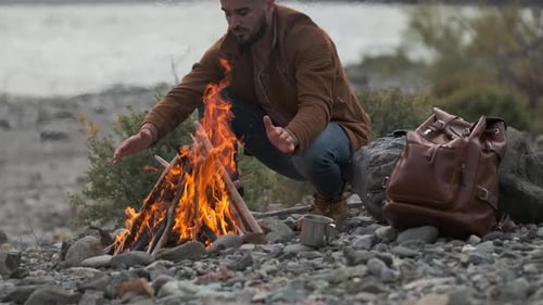 Hiker Tourist Traveler Man with Backpack Mountain Camping Fire Firewood Camp Tent Traveling Hiking