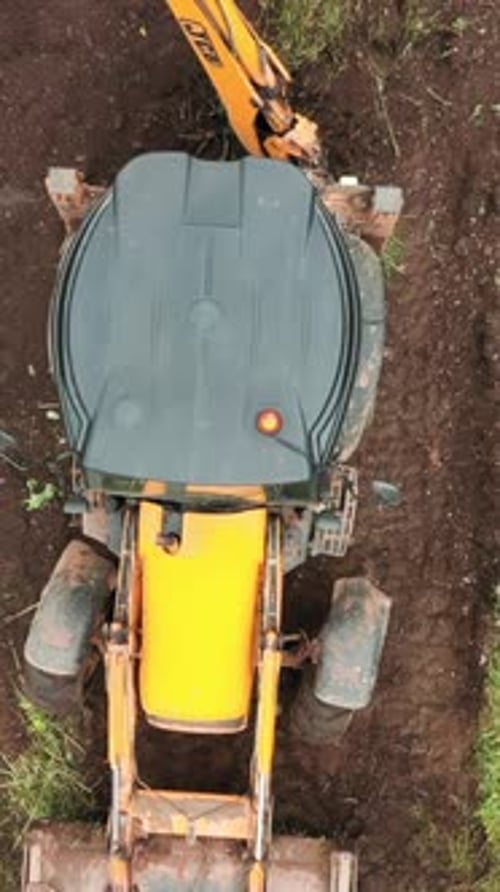 Top View of Excavator Working in Field Clip Bulldozer Clears Plot of Land with Green Thickets