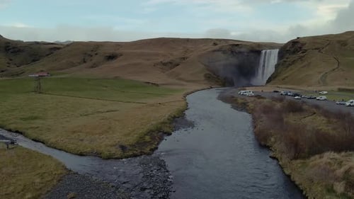 A drone pushes forward toward Skógafoss Waterfall in Iceland.