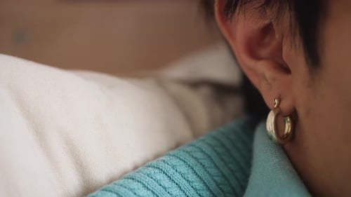 Close Up of Gold Hoop Earring Being Removed