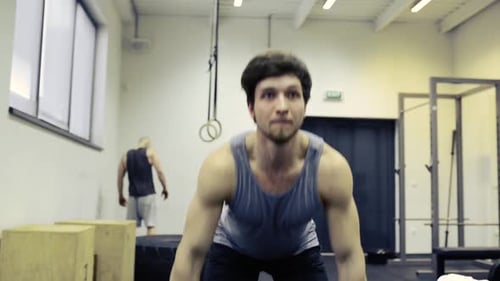 Young Muscular Man in Gym Lifting Heavy Barbell Active