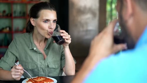 Woman Eating Pasta with Man at Home