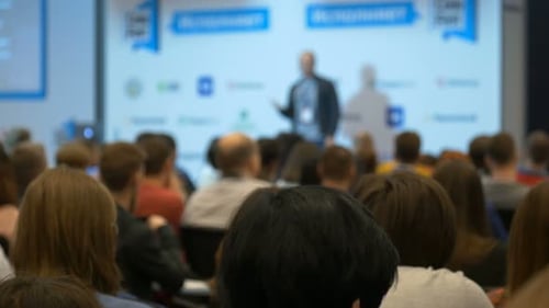 Audience Listening to Speaker at Corporate Conference