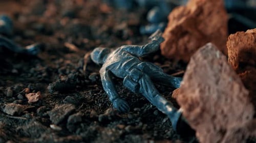 Plastic toy soldier melting on battlefield concept
