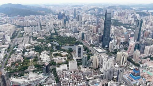 Aerial view over Shenzhen cityscape with massive urban development and skyscrapers.