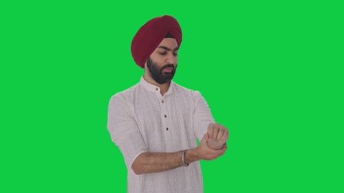 Sick Sikh Indian man suffering from hand pain Green screen