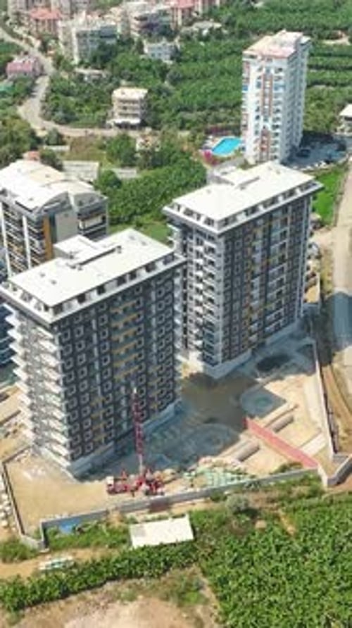 Vertical Video Building a Skyscraper Facade Construction and Material Delivery to Different Floors