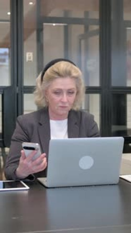 Senior Old Business Woman Using Phone with Laptop, Vertical Video