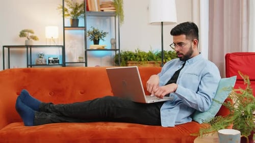 Man Relaxing at Home Using Laptop