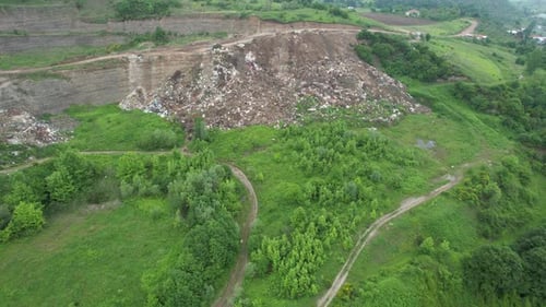 Expansive Landfill Amidst Green, Hilly Environment