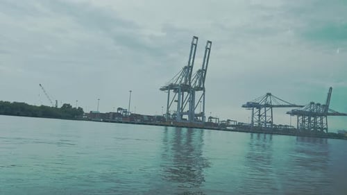 view of three harbor cranes during cloudy sky in the sea cargo port in 4k