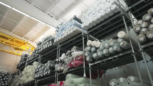 Textile Rolls are Stored on Industrial Warehouse Shelves Concept of Textile Industry