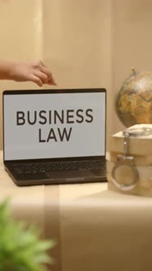 VERTICAL VIDEO OF BUSINESS LAW DISPLAYED IN LEGAL LAPTOP SCREEN