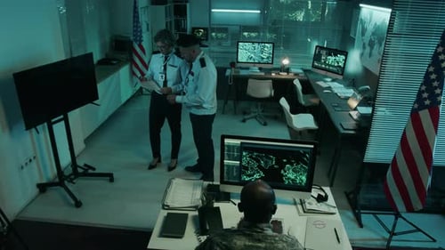 Multiethnic Military Team Working with Intelligence Data in Operations Center