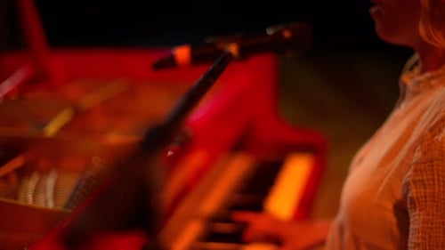 Woman Playing Piano and Singing at Night