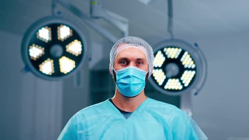 Surgeon in Scrubs Wearing a Mask in Operating Room