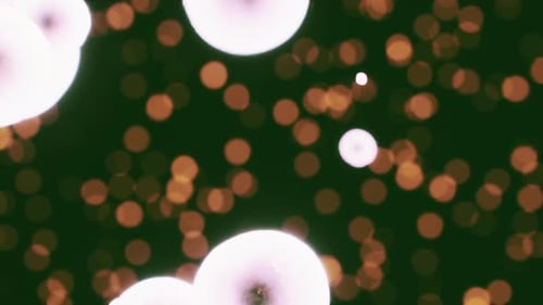 Abstract Glowing Spheres Floating with Warm Bokeh Lights Background