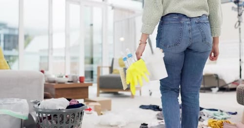 Woman, housekeeper and cleaning basket in dirty living room, germ or bacteria removal at home
