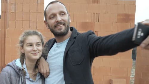 Happy Father with His Daughter Taking Selfie Photo at Construction Site Of