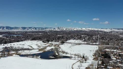 A drone pan over a park after a spring snow storm