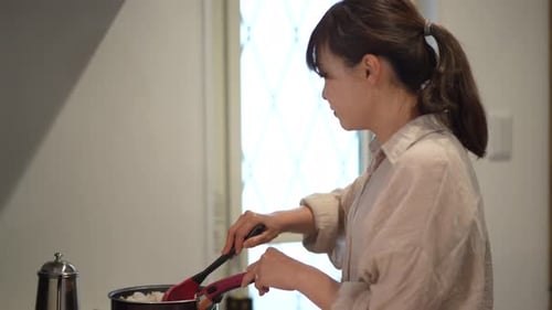 Woman Cooking Meal at Home in Kitchen