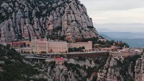 Aerial View of Santa Maria De Montserrat Monastery on Mountain Montserrat Cloudy Autumn Weather Slow