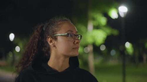 Serene Woman Gazes Quietly Calm Female Silhouette Under City Trees An Introspective Young Lady
