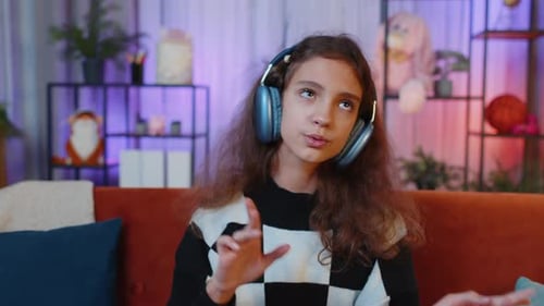 Teen Girl Dancing with Headphones at Home