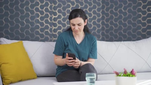 Woman Reacting Emotionally to Content on Smartphone
