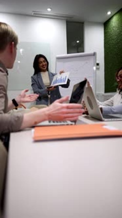 Businesswoman leading presentation during office meeting