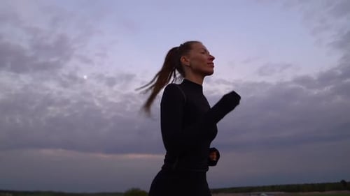 Woman Running Outdoors at Sunrise