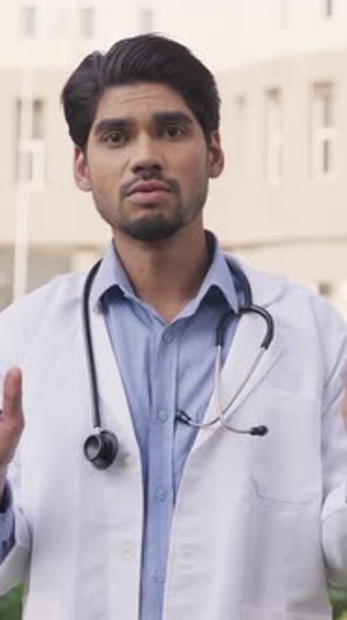 Young Doctor Wearing White Coat Explaining Medical Advice