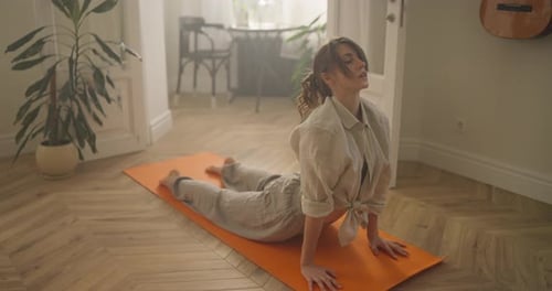 Young Woman Doing Yoga Exercise at Home