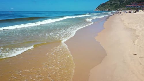 Aerial Top view of a transparent blue sea with beautiful waves at sunny day in summer. air of ocean