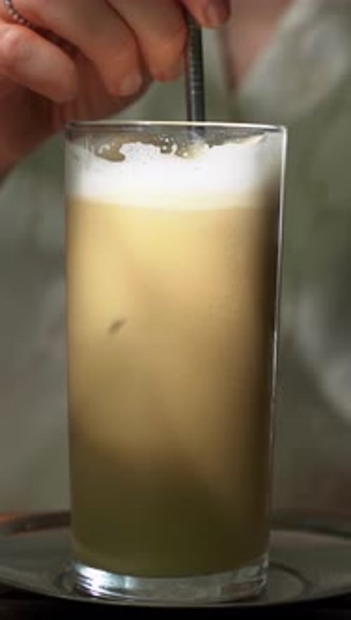 Iced Coffee in a Glass on a Table in a Summer Cafe Summer Cafe and Cold Drink Vertical Video