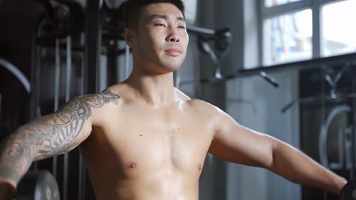 Strong muscular sportsman athlete doing weightlifting exercises with barbell modern gym sport club