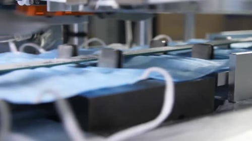 Production Line Connects Elastic Bands to Blue Medical Masks