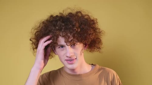Young Adult with Curly Hair Smiling