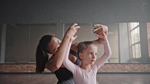 Experienced Coach Stretches Little Girl Before Ballet Dance