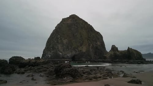 Wide Aerial Shot of Haystack Rock Beach in Coastal Town Cannon Beach Oregon