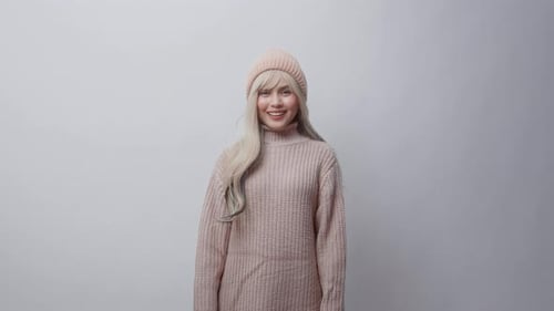 Smiling Woman in Pink Sweater and Hat