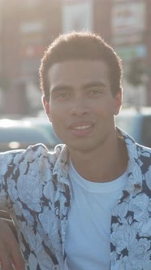 Smiling Guy on City Street Genuine Laugh Captured of Young Man During Golden Hour in Bustling City