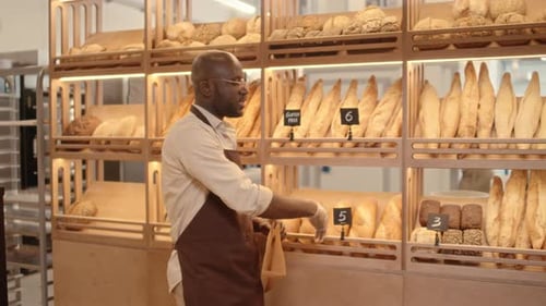 African American Seller Working at Bakery