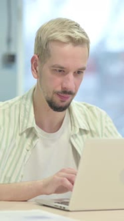 Young Man Reacting to Loss at Work