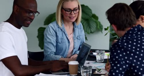 Professionals Collaborate on Business Project in Modern Office