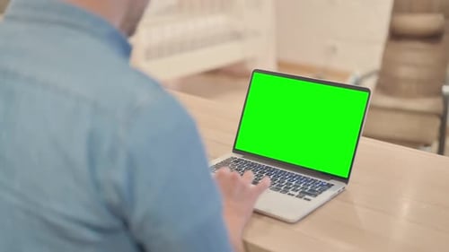 Mature Man Using Laptop with Chroma Key Screen
