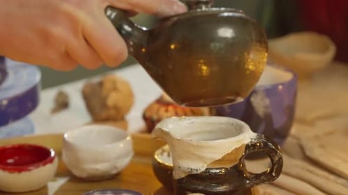 Atmospheric Setting of Pouring Tea Into Cups at Class