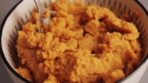 Vegetable baby puree in a deep bowl with a spoon. Smooth texture. Rabbit and vegetable baby puree.