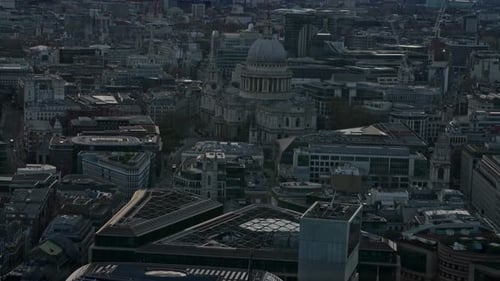 Aerial tilt up shot showing of London Cityscape and St.Pauls cathedral with colorful sunset in backg